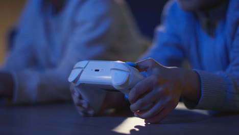 Close-Up-Of-Two-Young-Boys-At-Home-Playing-With-Computer-Games-Console-On-TV-Holding-Controllers-Late-At-Night-6
